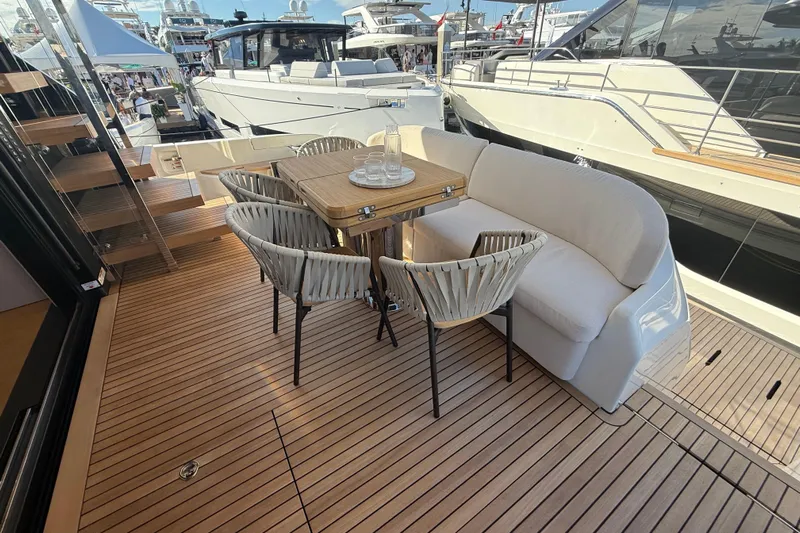  Yacht Photos Pics Luxurious 2026 Cranchi 62 yacht deck with elegant seating and dining area.