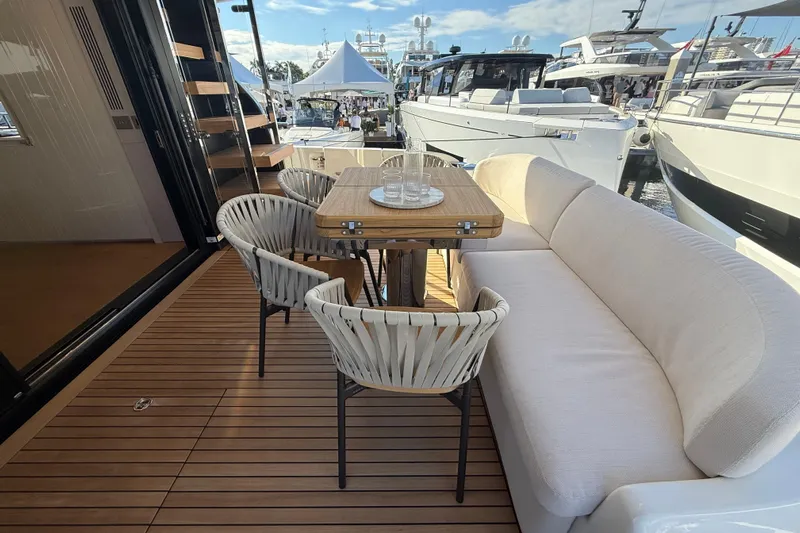  Yacht Photos Pics Luxurious 2026 Cranchi 62 yacht deck with elegant seating and dining area.