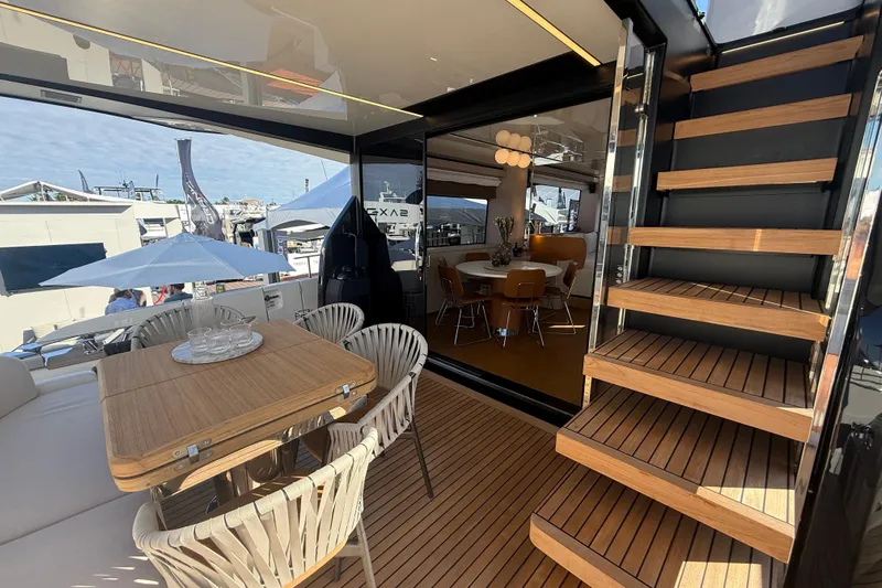  Yacht Photos Pics Luxurious interior of 2026 Cranchi 62 yacht with elegant dining area and wooden staircase.