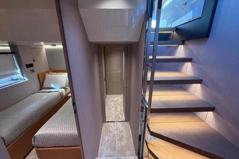  Yacht Photos Pics Luxurious interior of 2026 Cranchi 62 yacht featuring modern staircase and cozy bedroom.
