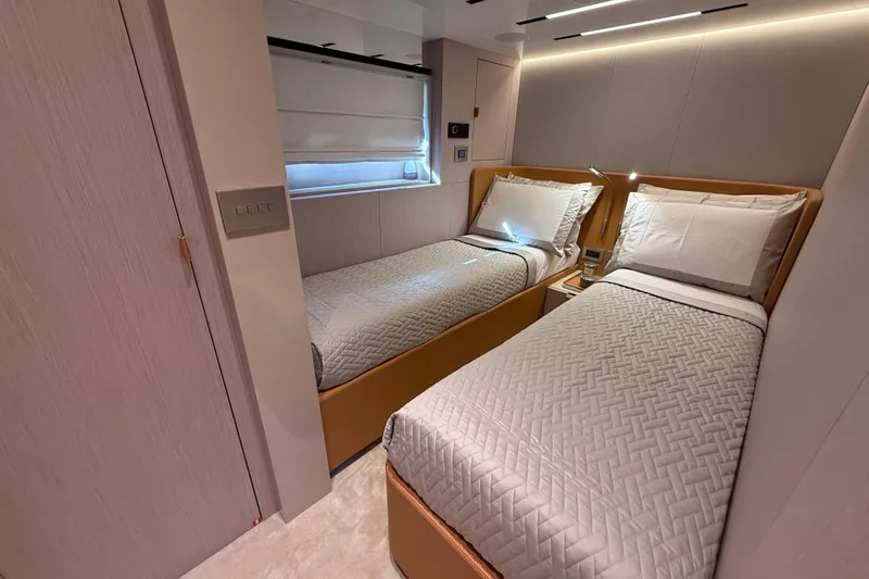 Yacht Photos Pics Luxurious twin bedroom in 2026 Cranchi 62 yacht, featuring modern design and ambient lighting.