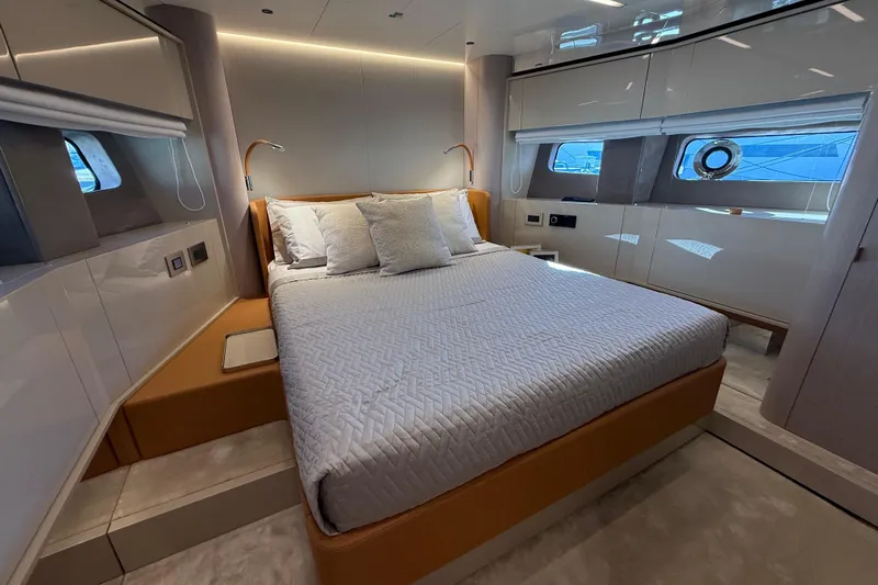 Yacht Photos Pics Luxurious bedroom interior of 2026 Cranchi 62 yacht with modern design and elegant furnishings.