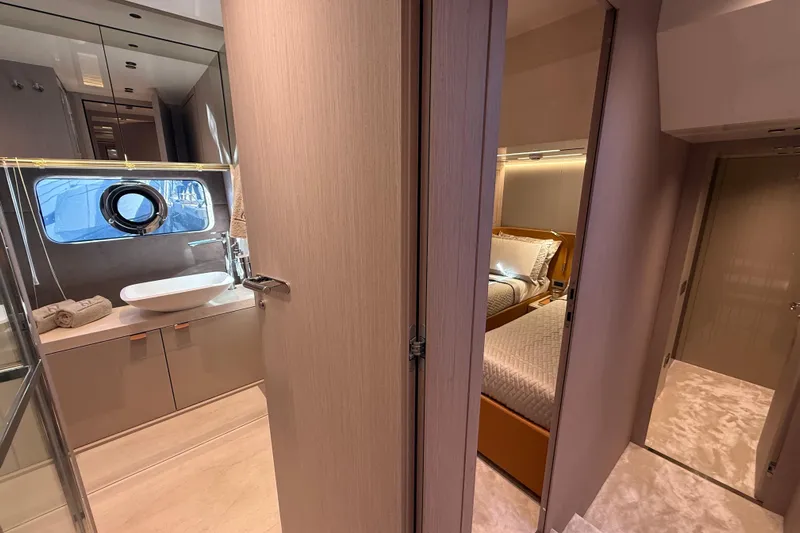  Yacht Photos Pics Luxurious interior of 2026 Cranchi 62 yacht featuring a modern bathroom and cozy bedroom.