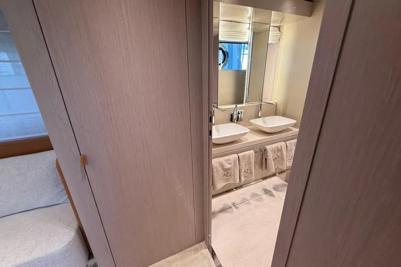  Yacht Photos Pics Luxurious bathroom interior of 2026 Cranchi 62 yacht with dual sinks and elegant design.
