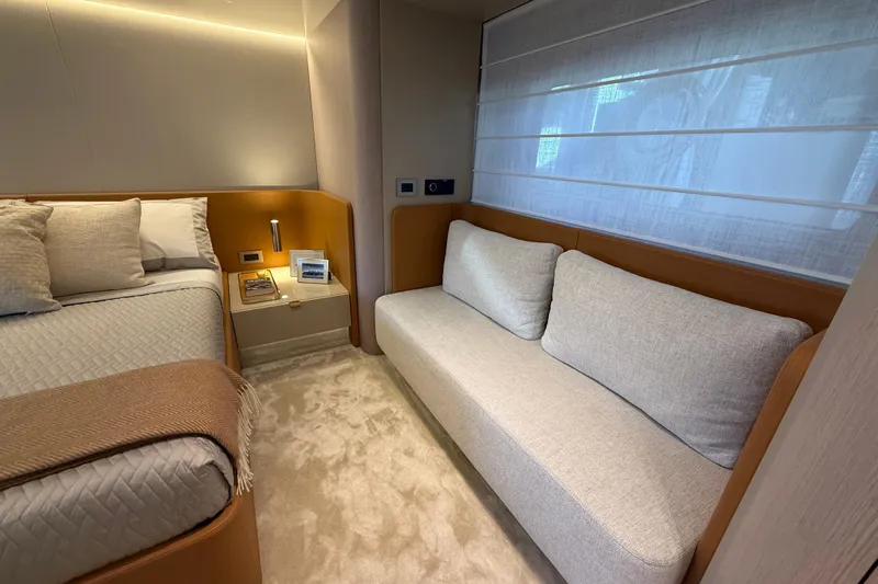  Yacht Photos Pics Luxurious 2026 Cranchi 62 yacht interior with cozy bed, sofa, and elegant decor.