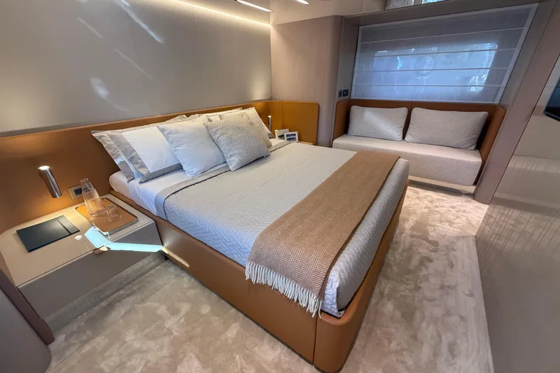 Yacht Photos Pics Luxurious bedroom interior of 2026 Cranchi 62 yacht with modern design and cozy furnishings.