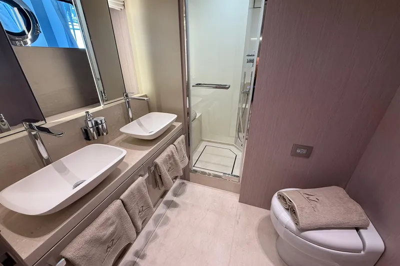  Yacht Photos Pics Luxurious bathroom in 2026 Cranchi 62 yacht with dual sinks and modern shower.