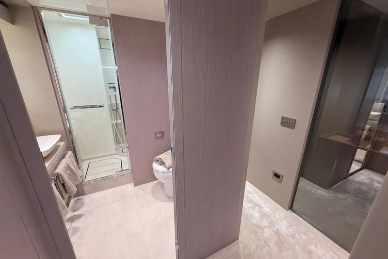  Yacht Photos Pics Luxurious bathroom interior of 2026 Cranchi 62 yacht, featuring modern shower and toilet.