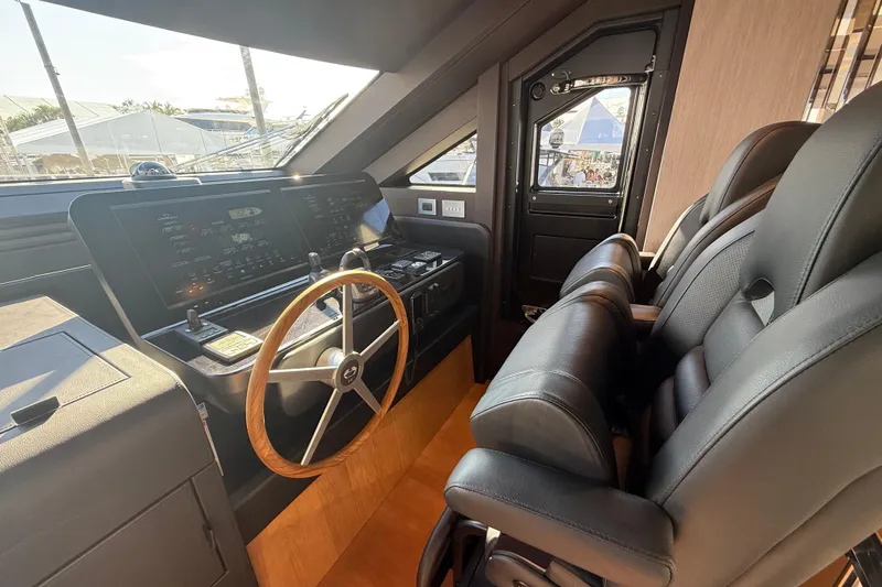  Yacht Photos Pics Luxurious 2026 Cranchi 62 yacht cockpit with modern controls and leather seating.