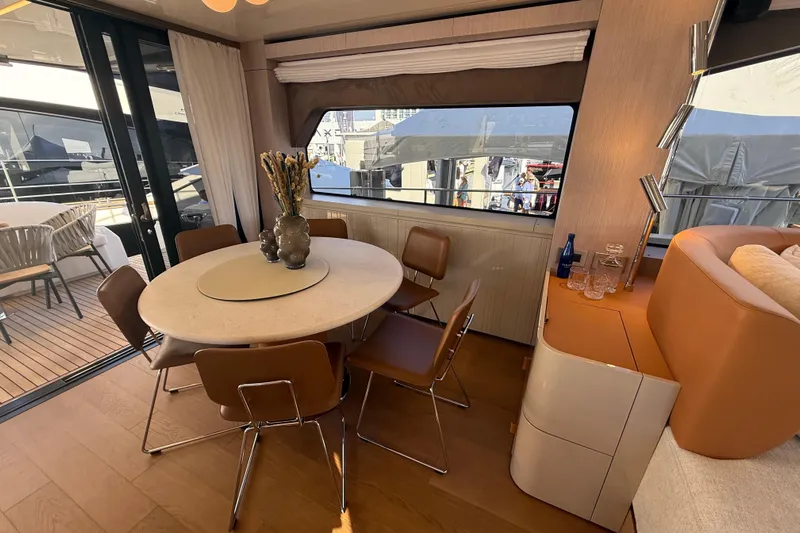  Yacht Photos Pics Luxurious interior of 2026 Cranchi 62 yacht with elegant dining area and modern decor.