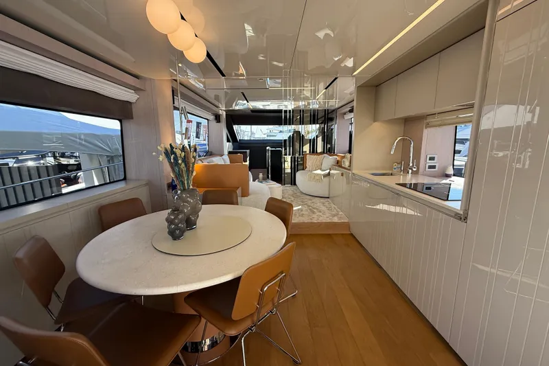  Yacht Photos Pics Luxurious interior of 2026 Cranchi 62 yacht with modern dining and kitchen area.