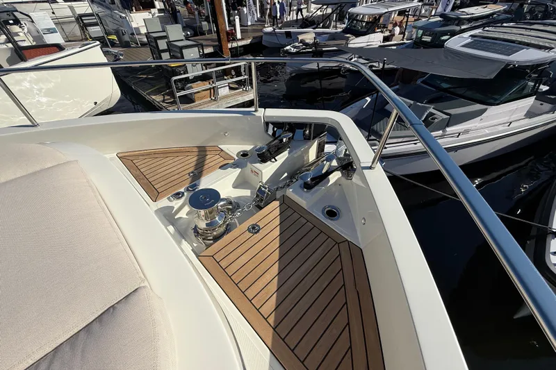  Yacht Photos Pics Luxury Cranchi 62 yacht deck with teak flooring, 2026 model, docked at marina.