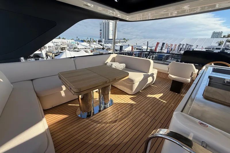  Yacht Photos Pics Luxurious 2026 Cranchi 62 yacht deck with elegant seating and wooden flooring.