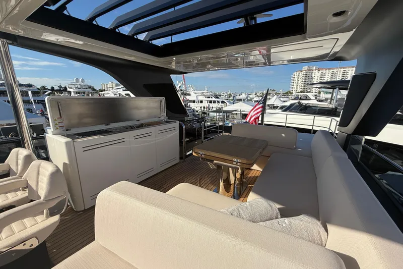  Yacht Photos Pics Luxurious 2026 Cranchi 62 yacht interior with seating, table, and outdoor kitchen.