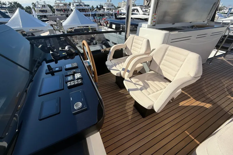  Yacht Photos Pics Luxurious helm of 2026 Cranchi 62 yacht with modern controls and plush seating.