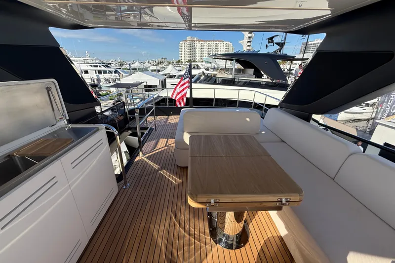  Yacht Photos Pics Luxurious 2026 Cranchi 62 yacht deck with seating, table, and marina view.