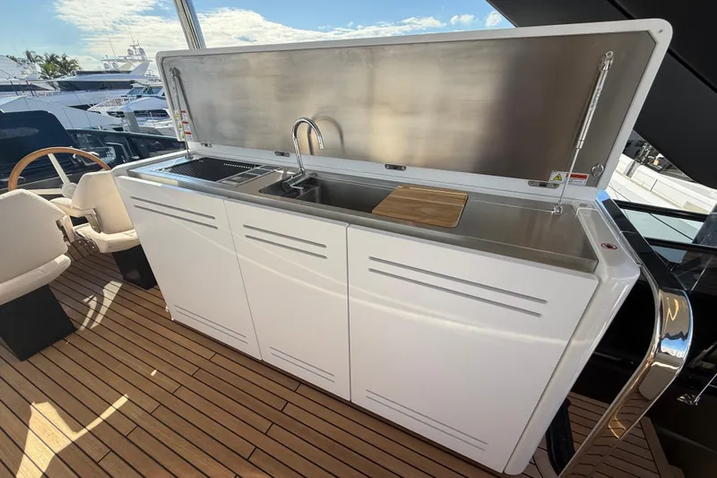  Yacht Photos Pics Outdoor kitchen on 2026 Cranchi 62 yacht with sink and cutting board.