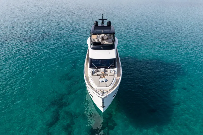  Yacht Photos Pics 2026 Cranchi 62 Sessantadue yacht on clear turquoise water, aerial view.