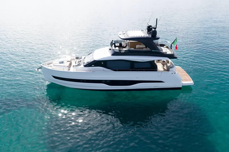  Yacht Photos Pics 2026 Cranchi 62 Sessantadue yacht on clear blue water, showcasing sleek design and luxury features.