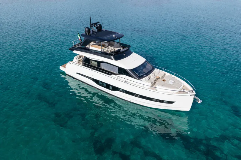  Yacht Photos Pics 2026 Cranchi 62 Sessantadue yacht on clear blue water, aerial view.