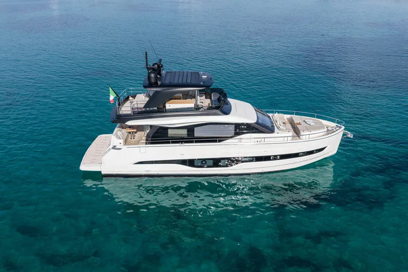  Yacht Photos Pics 2026 Cranchi 62 Sessantadue yacht on clear blue water, side view.