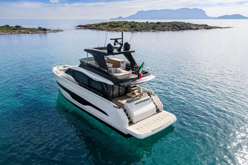  Yacht Photos Pics Luxury 2026 Cranchi 62 Sessantadue yacht on serene blue waters near an island.