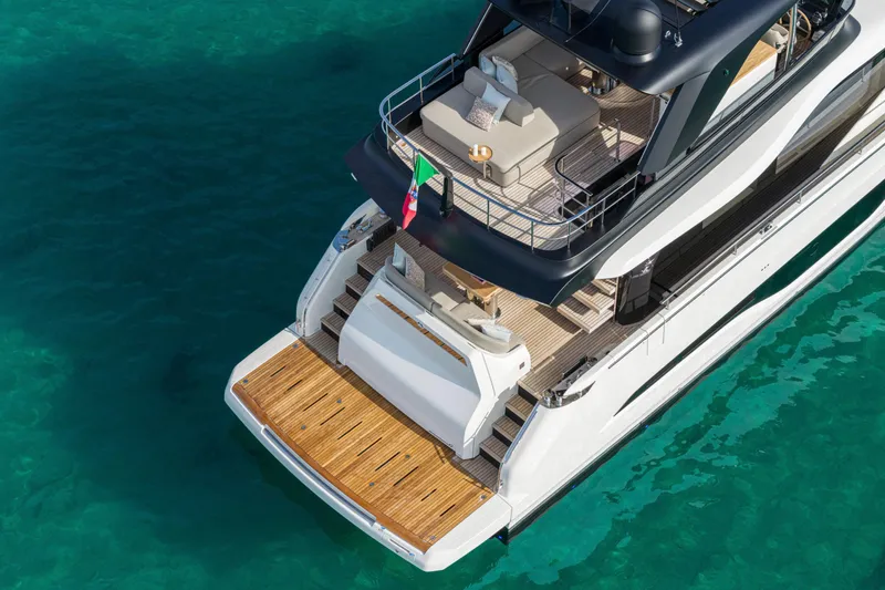  Yacht Photos Pics Luxury Cranchi 62 Sessantadue yacht, 2026 model, on clear turquoise water.