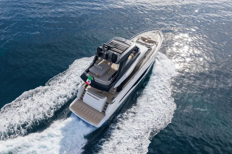  Yacht Photos Pics 2026 Cranchi 62 Sessantadue yacht cruising on open water, aerial view.