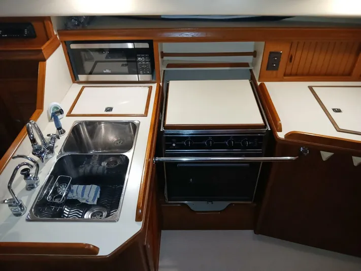 Wonderwind Yacht Photos Pics 1999 Island Packet 45 yacht kitchen with sink, stove, and microwave.