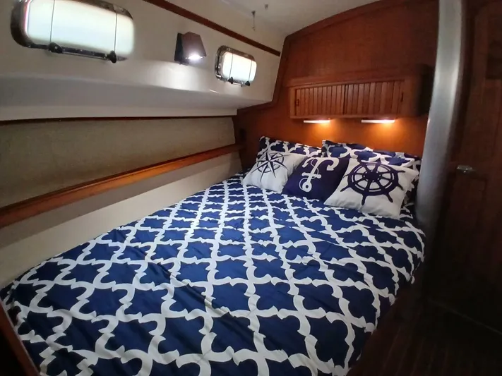 Wonderwind Yacht Photos Pics Cozy cabin interior of 1999 Island Packet 45 sailboat with nautical-themed bedding.