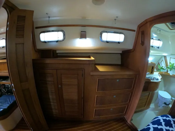 Wonderwind Yacht Photos Pics Interior of 1999 Island Packet 45 sailboat with wooden cabinetry and bathroom view.