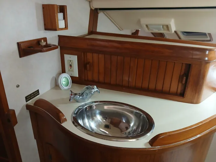 Wonderwind Yacht Photos Pics Interior of 1999 Island Packet 45 yacht with wooden cabinetry and stainless steel sink.