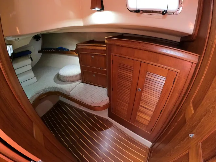 Wonderwind Yacht Photos Pics Interior of 1999 Island Packet 45 sailboat with wooden cabinetry and cozy seating area.