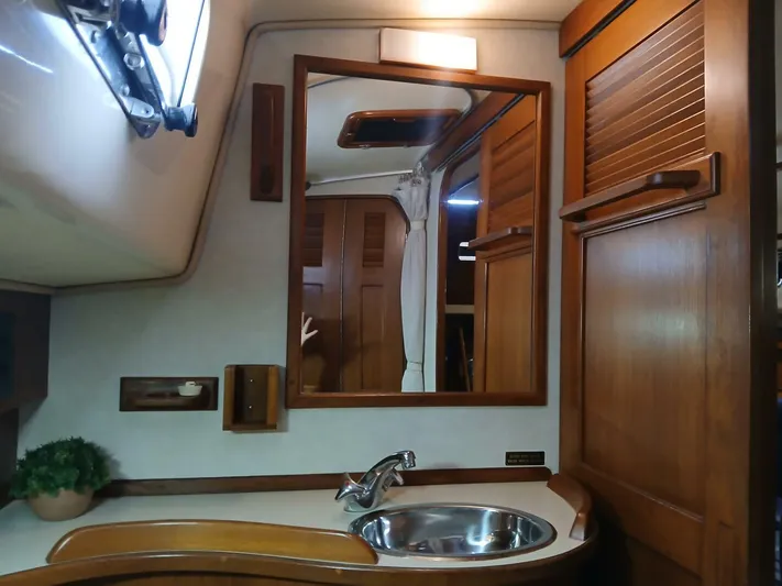 Wonderwind Yacht Photos Pics Interior of 1999 Island Packet 45 yacht with wooden cabinetry and sink.