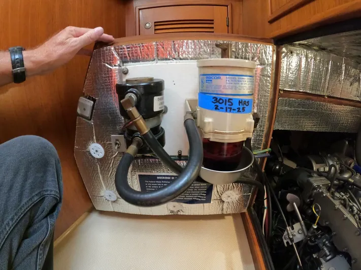 Wonderwind Yacht Photos Pics Engine compartment of a 1999 Island Packet 45 sailboat, featuring fuel filter and insulation.