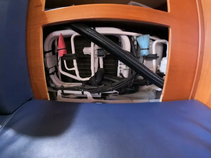 Wonderwind Yacht Photos Pics 1999 Island Packet 45 interior showing plumbing and wiring behind wooden panel.