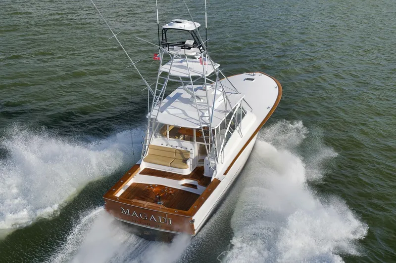 Magadi Yacht Photos Pics 2015 Ritchie Howell Express yacht cruising on open water, rear view.