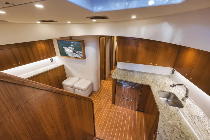 Magadi Yacht Photos Pics Luxurious interior of 2015 Ritchie Howell Express yacht with wooden cabinetry and granite countertops.