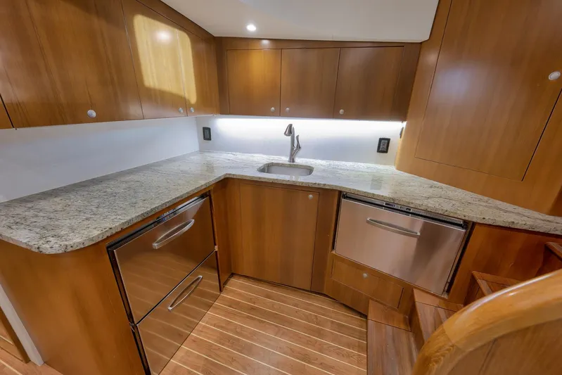 Magadi Yacht Photos Pics Luxurious 2015 Ritchie Howell Express yacht kitchen with wood cabinetry and granite countertops.