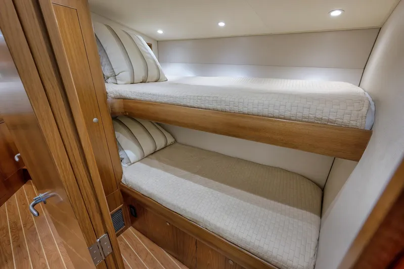 Magadi Yacht Photos Pics 2015 Ritchie Howell Express interior with wooden bunk beds and striped pillows.