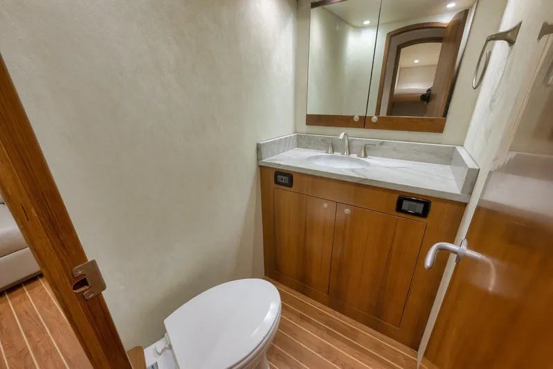 Magadi Yacht Photos Pics Luxurious bathroom in 2015 Ritchie Howell Express yacht with wooden cabinetry and modern fixtures.