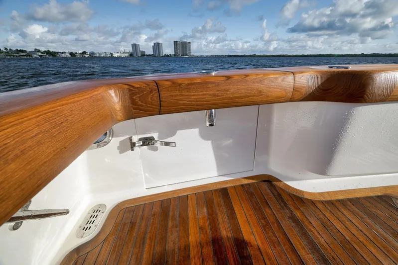 Magadi Yacht Photos Pics 2015 Ritchie Howell Express boat with wooden deck and scenic waterfront view.