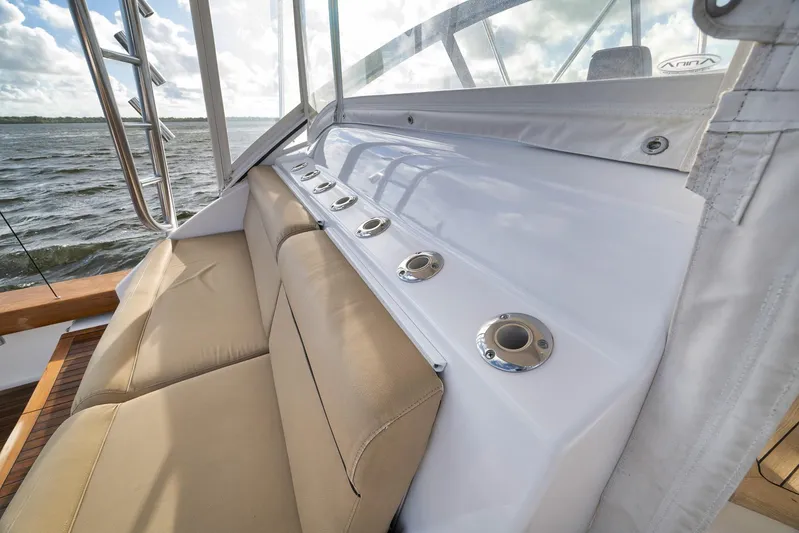 Magadi Yacht Photos Pics 2015 Ritchie Howell Express boat with beige seating and rod holders, on a sunny day.