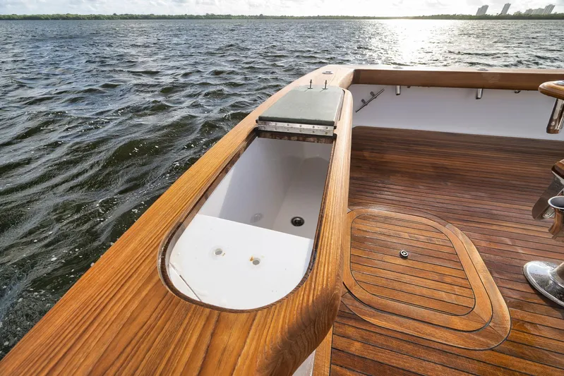 Magadi Yacht Photos Pics 2015 Ritchie Howell Express boat deck with wooden finish, overlooking calm waters.