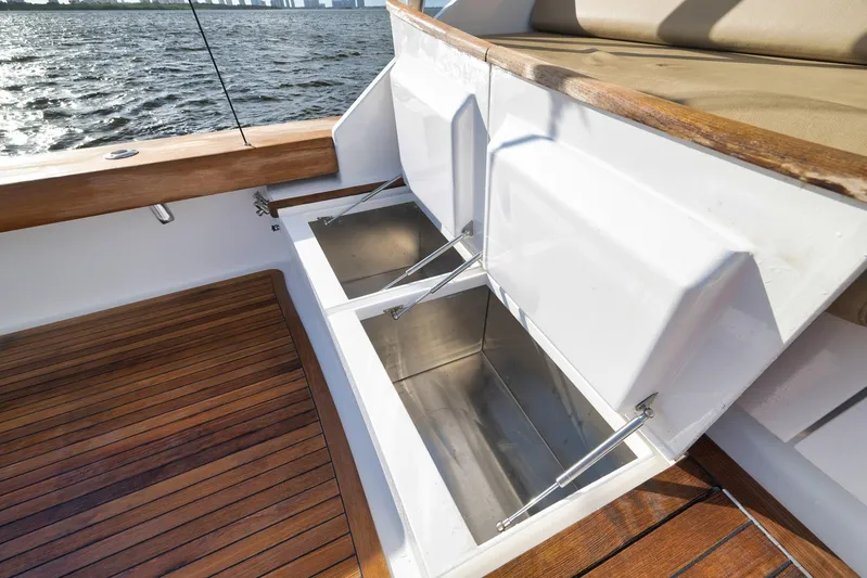Magadi Yacht Photos Pics 2015 Ritchie Howell Express boat with open storage compartments and wooden deck.