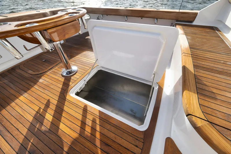 Magadi Yacht Photos Pics 2015 Ritchie Howell Express boat deck with open storage compartment and wooden finish.