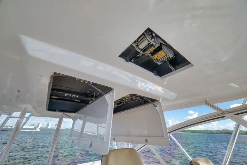 Magadi Yacht Photos Pics 2015 Ritchie Howell Express boat interior with open ceiling compartments, overlooking water and skyline.