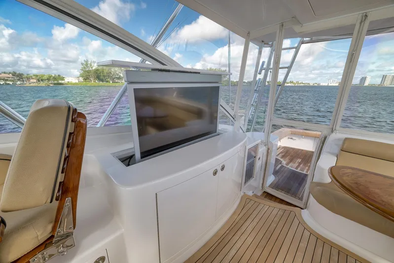 Magadi Yacht Photos Pics Luxurious 2015 Ritchie Howell Express yacht interior with TV, seating, and scenic water view.