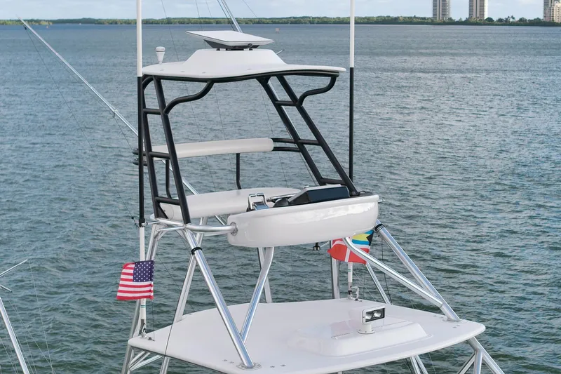 Magadi Yacht Photos Pics 2015 Ritchie Howell Express boat tower with flags, overlooking calm waters.