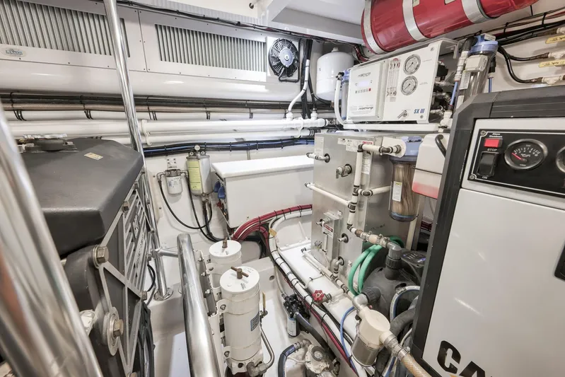 Magadi Yacht Photos Pics Engine room of 2015 Ritchie Howell Express boat, featuring complex machinery and piping.